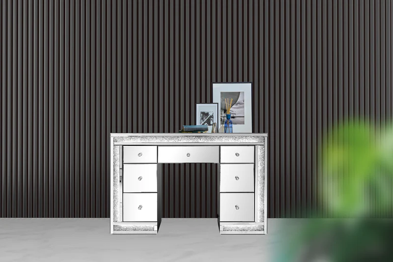 Dresser with mirror and picture frames on top, against a striped wall background.