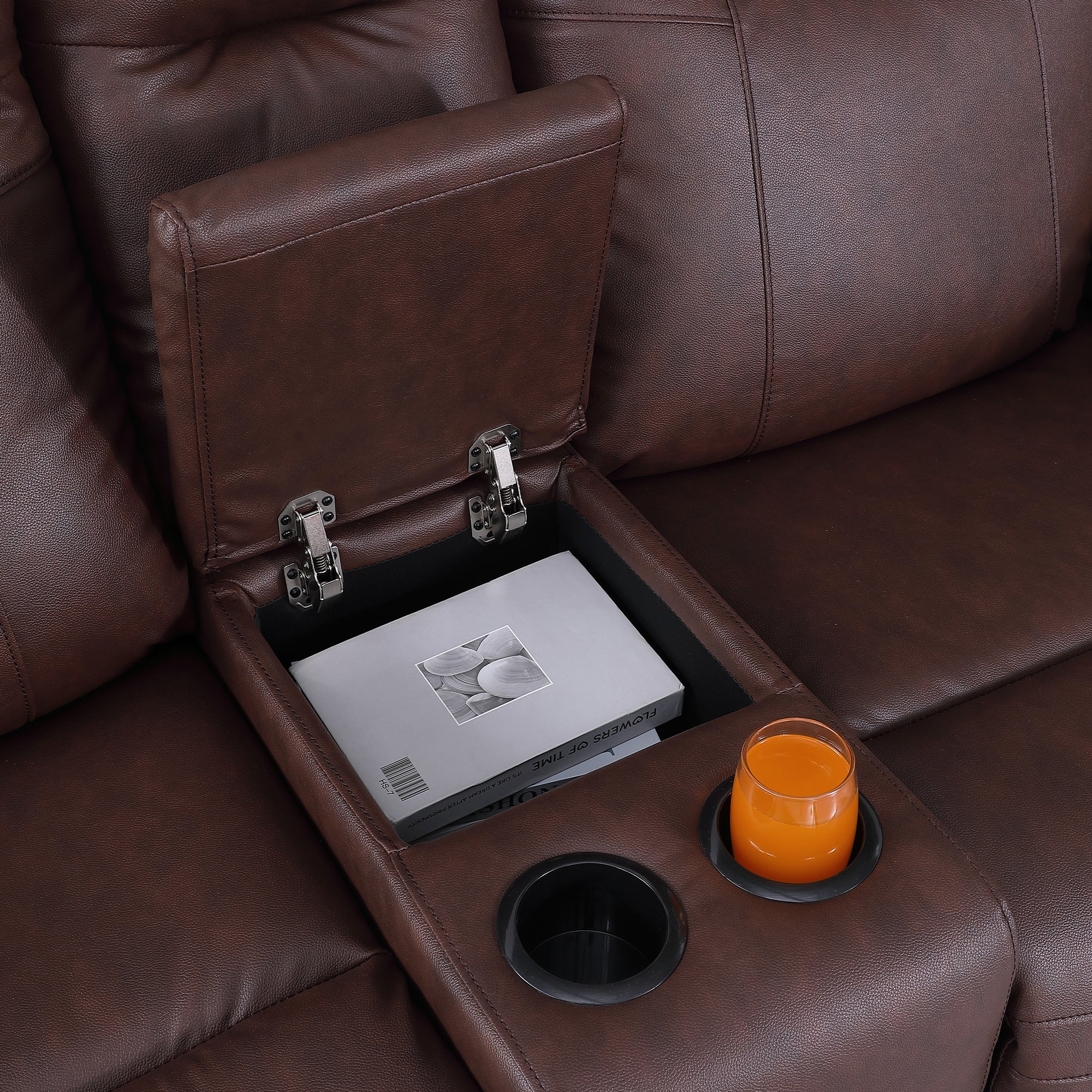 The flip-top storage compartment and two cup holders of the sofa
